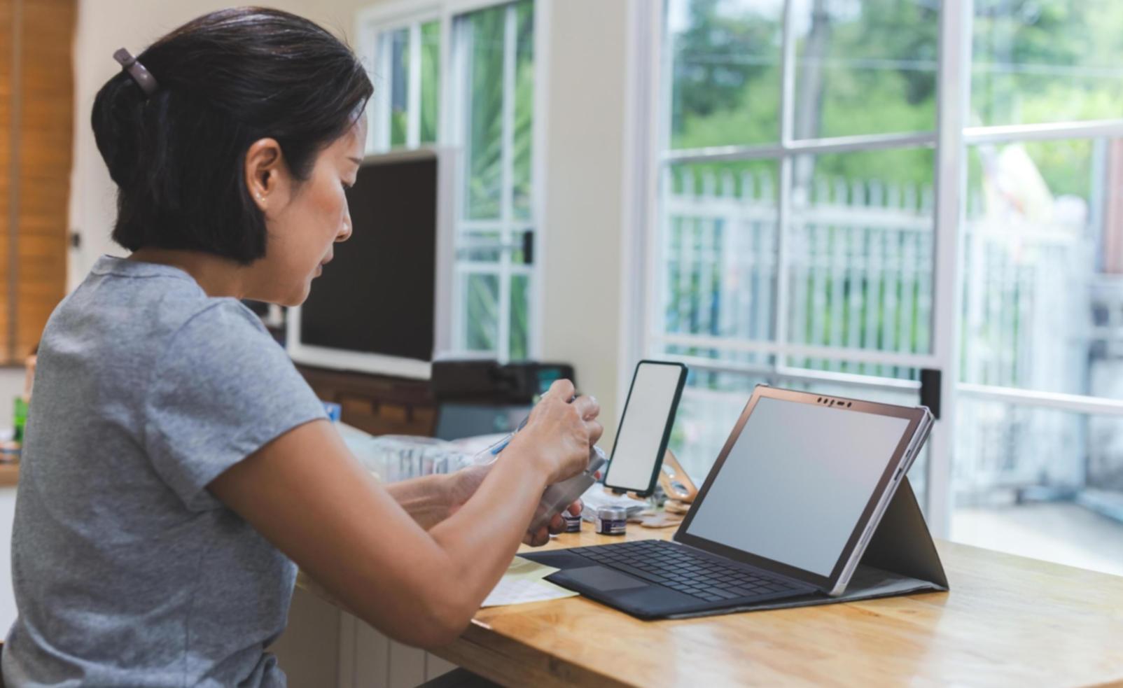 Focused student working on SEO optimization project with organized notes and laptop setup